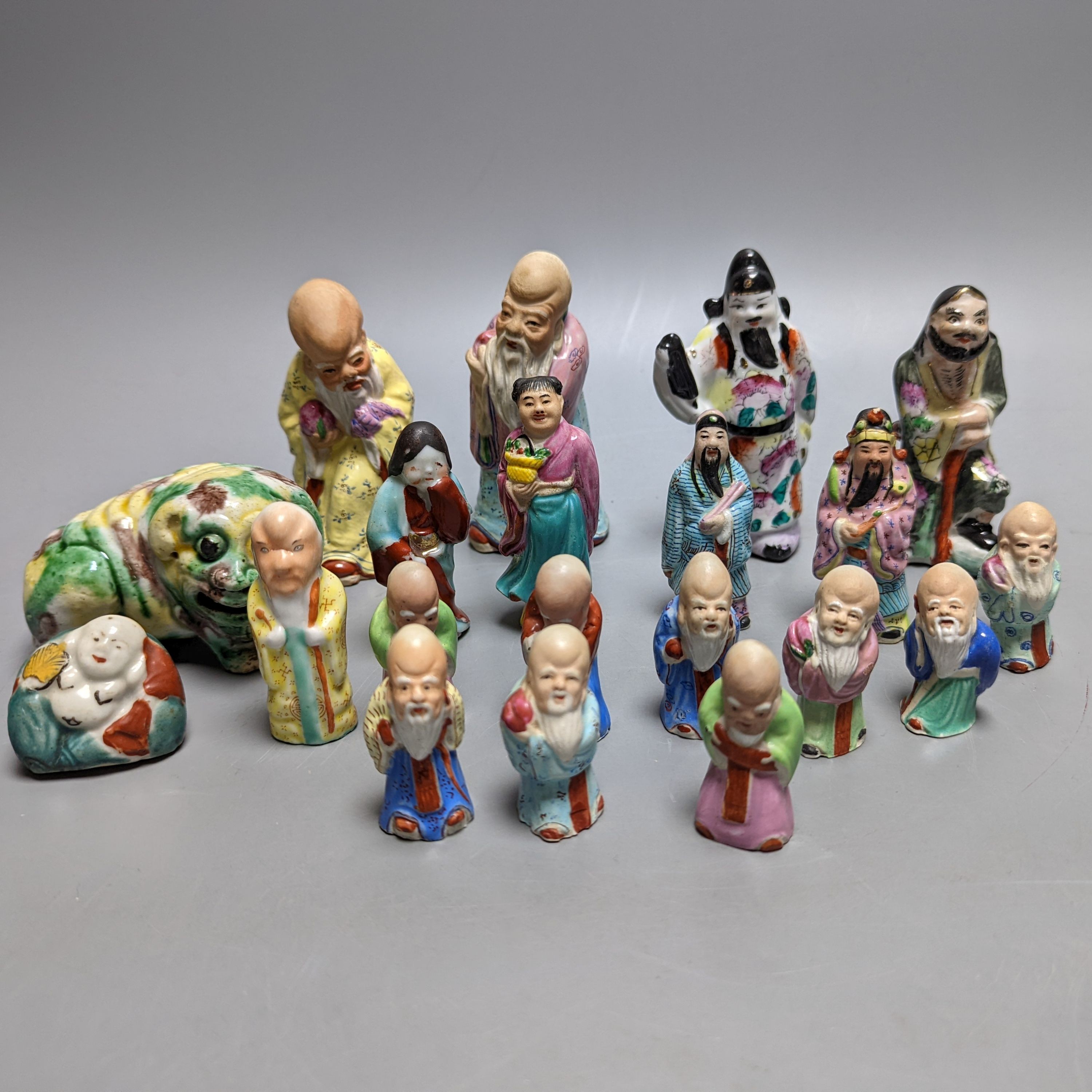 A collection of Chinese enamelled porcelain miniature figurines, including a 19th century Chinese sancai enamelled biscuit figure of a beast, 9cm